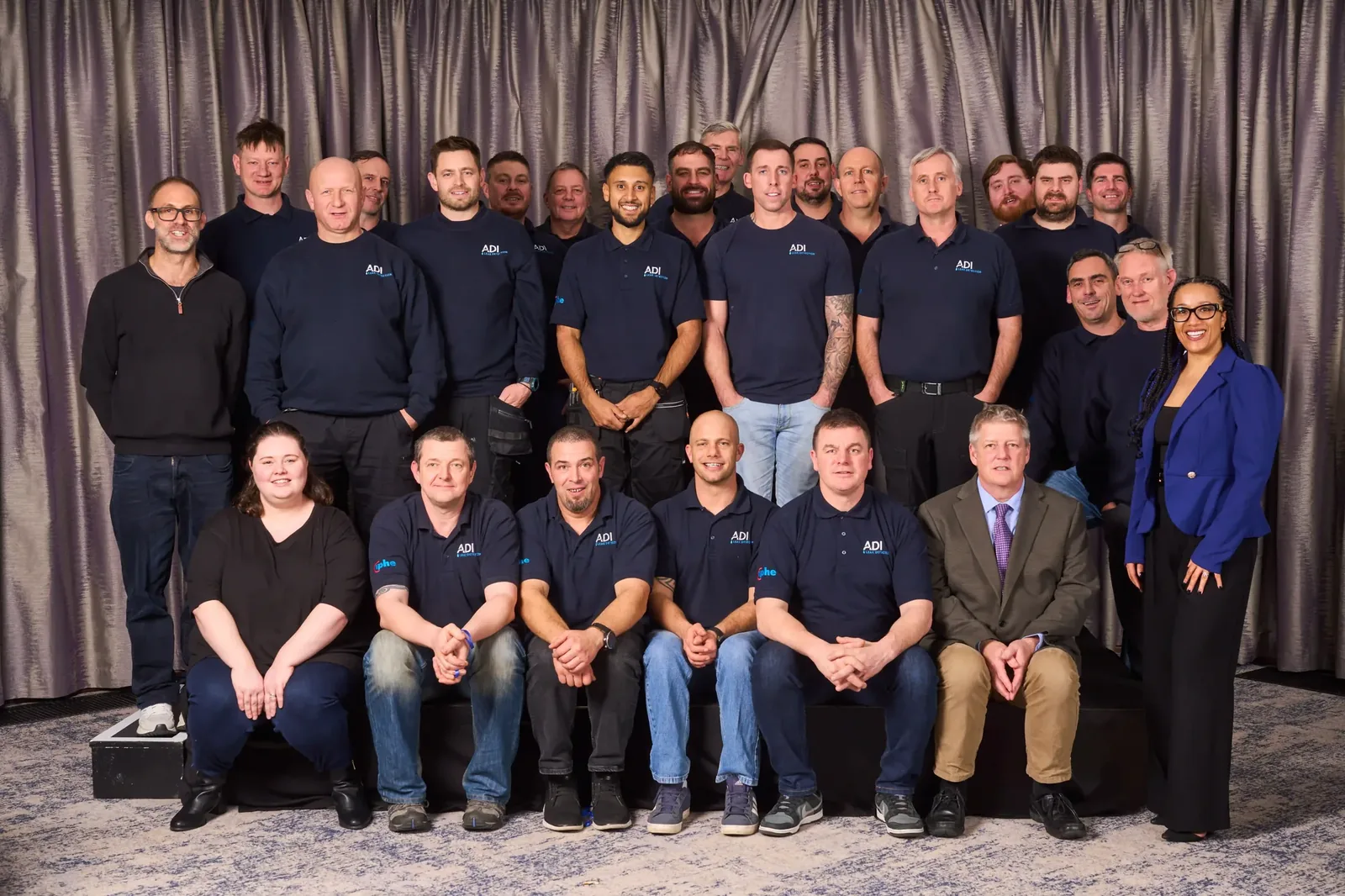 The ADI Leak Detection team photographed together, engineers in ADI polo shirts alongside the office and leadership team